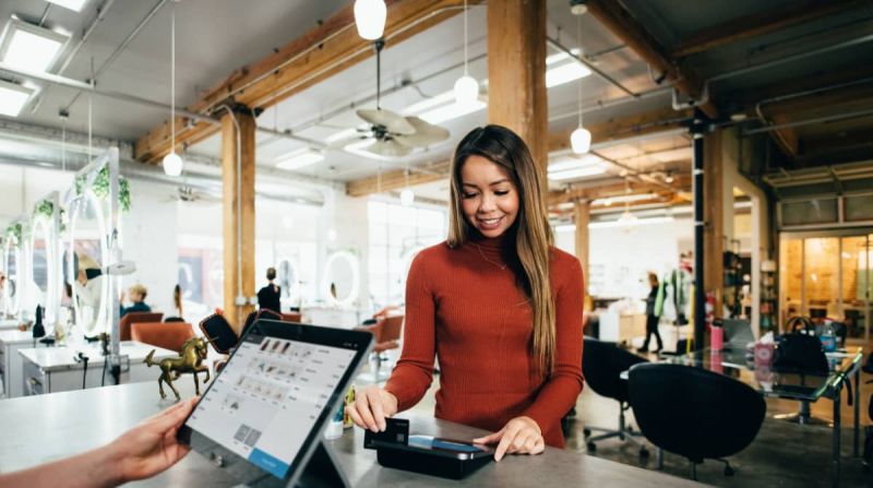 Woman pays at counter in store