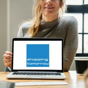 Vrouw met laptop wijst naar ShoppingTomorrow logo